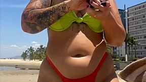 casada drawing eyes at the beach, flashing in a tight bikini with style