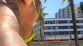 casada drawing eyes at the beach, flashing in a tight bikini with style