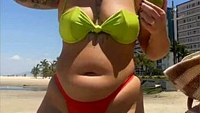 casada drawing eyes at the beach, flashing in a tight bikini with style