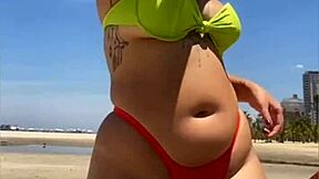 casada drawing eyes at the beach, flashing in a tight bikini with style