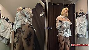 I’m peeking at a busty blonde trying lingerie in dressing room.