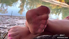 look at my cute feet in nude tights rubbing on the autumn river bank