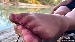 look at my cute feet in nude tights rubbing on the autumn river bank