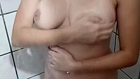 Redhead fingers her pink ass in shower!