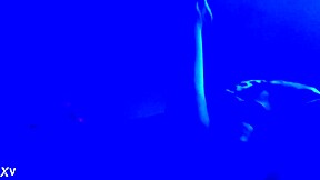 suggestive blacklight fetish with feet, toes, and footjob in dark setting.