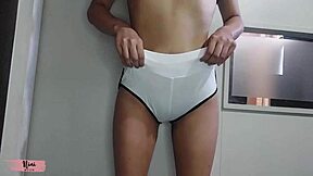 Nini tries on leggings in the store