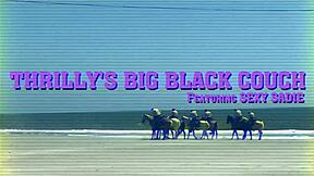 Sexy Sadie strips on Thrilly's big black couch for intense rimjob action.