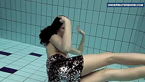 I flash my bright tits underwater in the pool, making everyone horny