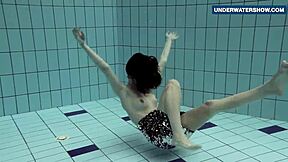 I flash my bright tits underwater in the pool, making everyone horny