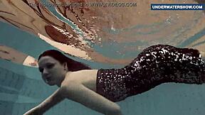 I flash my bright tits underwater in the pool, making everyone horny