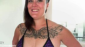 Kali Danes with tattooed big tits gives pov blowjob to huge cock and swallows cum
