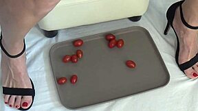 This mature housewife enjoys trampling tomatoes with her bare feet in a fun kitchen activity