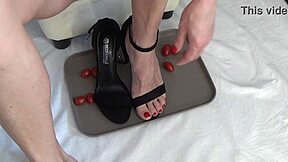 This mature housewife enjoys trampling tomatoes with her bare feet in a fun kitchen activity