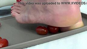 This mature housewife enjoys trampling tomatoes with her bare feet in a fun kitchen activity