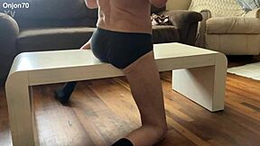 Skinny Bodybuilder Stretches on Desk in Underwear