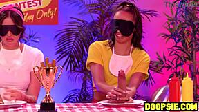 Kinky ebony contestant straps on dildo to pound curvy blonde competitor's ass