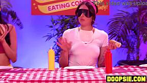 Kinky ebony contestant straps on dildo to pound curvy blonde competitor's ass