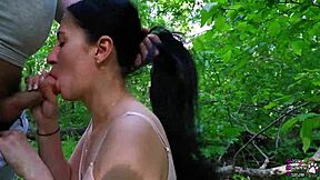 Watch this young brunette cocksucker make a fat cock cum in the forest
