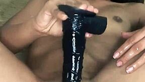 Pretty girl uses big black dildo on her small wet pussy.