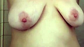 big boob mama showering while washing hair and shaving