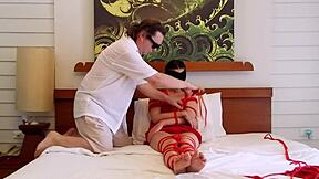 Sofi Tied Up in Red Ropes on Bed, Ready for Bondage Play?