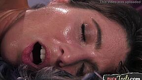 beautiful woman uses machine to spread legs, reaching orgasm with vibrator