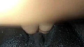 Black woman enjoys solo relaxation with wet elements in homemade session