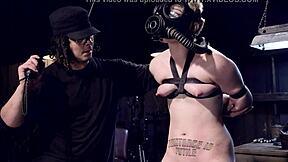 Blonde slave in gas mask gagged and choked in bondage