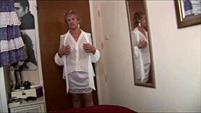 Naughty granny in see-through top and slip teasing and flashing