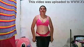 The blonde Latina in a pink blouse models while licking and sucking