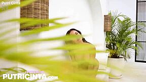 tanned asian babe putri cinta relaxes by the poolside