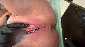 German milf rubs her pierced clit in latex gloves, releasing a hard pee stream