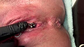 German milf rubs her pierced clit in latex gloves, releasing a hard pee stream