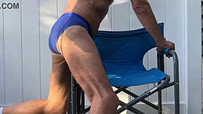Deep pelvic stretching in blue briefs on blue chair late october 2024