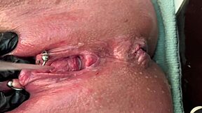 German milf rubs her pierced clit in latex gloves, releasing a hard pee stream