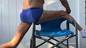 Deep pelvic stretching in blue briefs on blue chair late october 2024