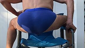 Deep pelvic stretching in blue briefs on blue chair late october 2024