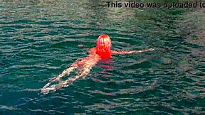 Blue water surrounds the naked girl in this public exhibition