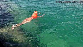 Blue water surrounds the naked girl in this public exhibition