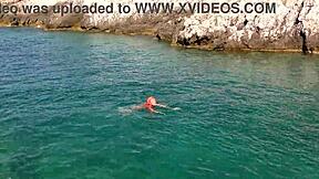 Blue water surrounds the naked girl in this public exhibition