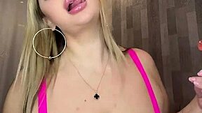 Sweet milf sucks candy while playing with her big natural tits.