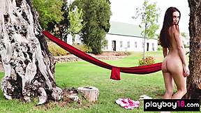 ukrainian beauty gloria sol relaxes outdoors in hammock