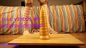 What is this blonde doing with huge anal toys?