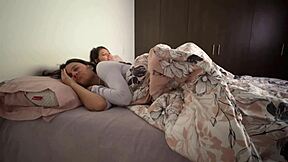 Lesbians snuggle in bed and touch their asses