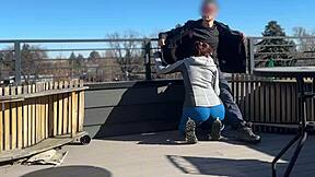 Little redhead slut gives fast handjob and blowjob on the roof.