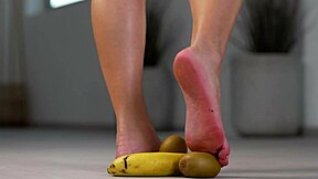 Petite girl crushes fruits under her high heels in hot foot fetish
