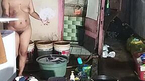 Indonesian housewife emak emak washes clothes while fingering her big hairy pussy!