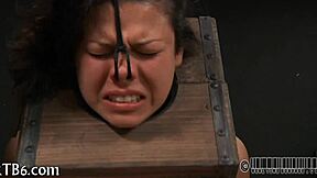 Girl strips seductively inside tight metal cage revealing all