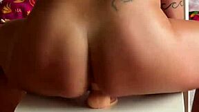 blonde goddess ketria rides huge dildo anal on chair shaking oiled ass