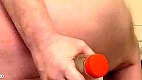 Stuffing water bottle deep into ass alongside massive dildos